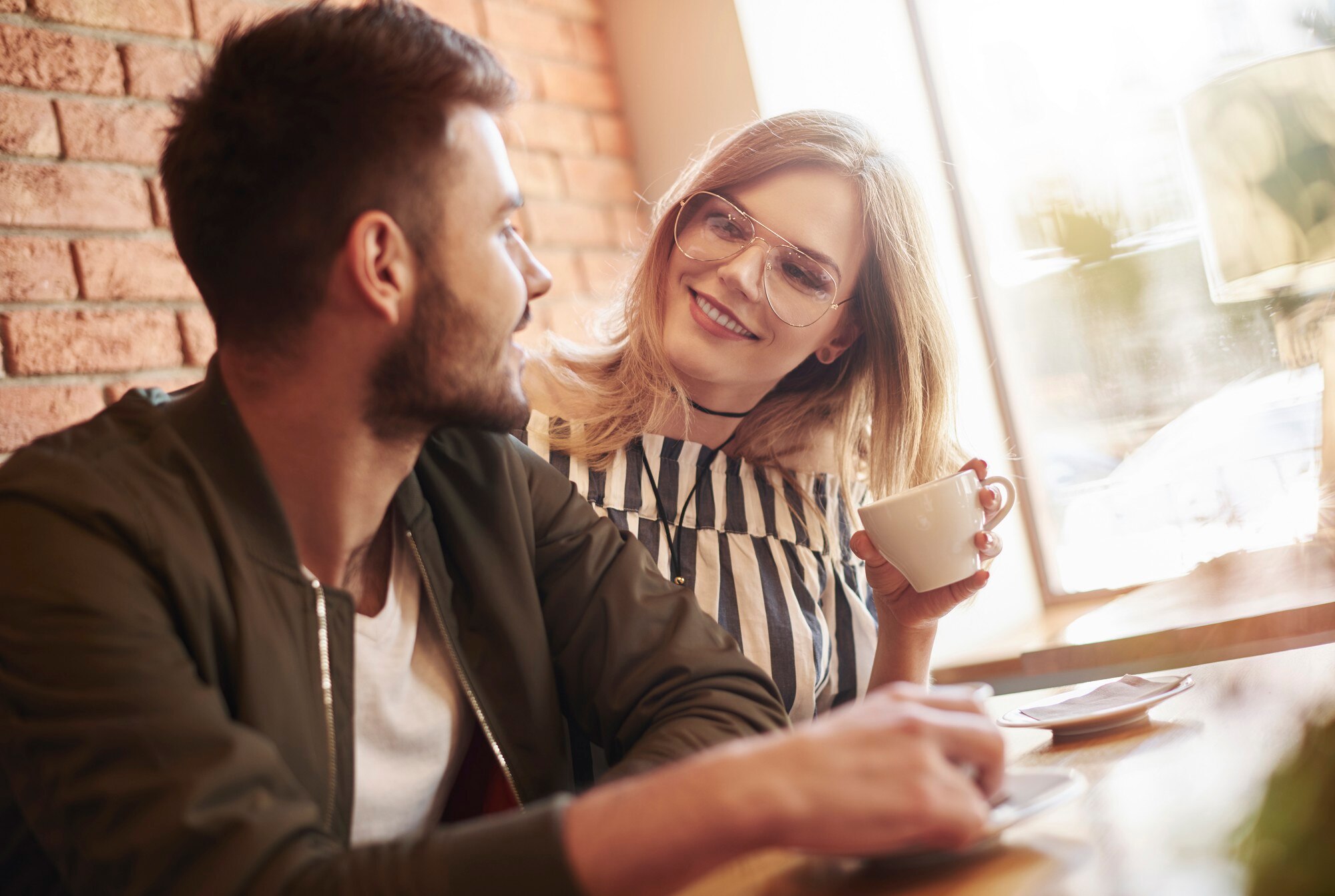 Jeune couple qui discute autour d’une tasse de café